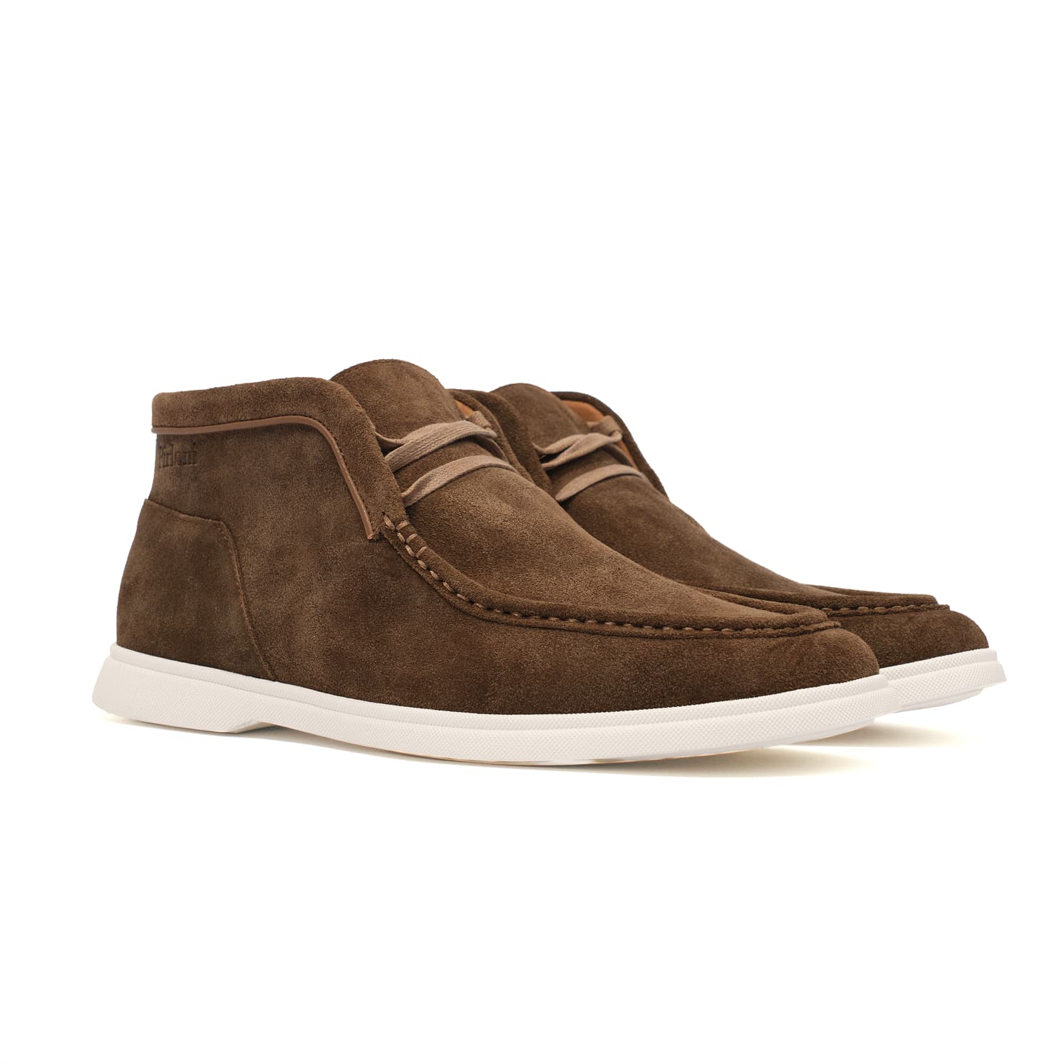 Brown suede shoes with white soles on a white background