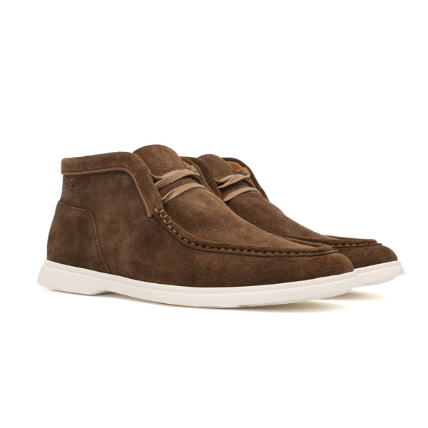 Brown suede shoes with white soles on a white background