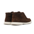 Pair of brown suede high-top shoes on a white background