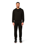 Man wearing a black hoodie and pants on a white background