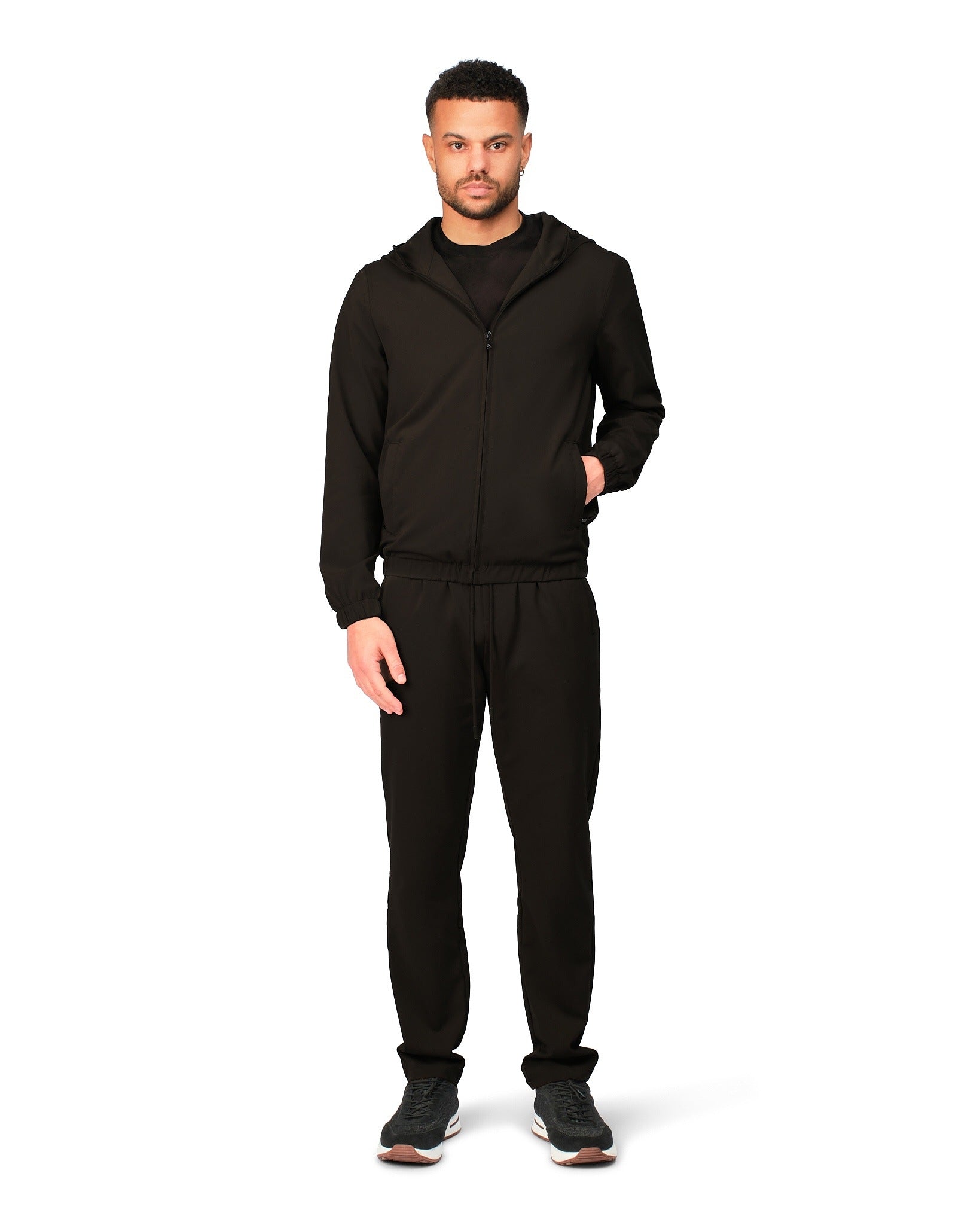 Man wearing a black tracksuit on a white background