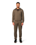 Man wearing a brown tracksuit on a white background