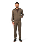 Man wearing a brown tracksuit on a white background