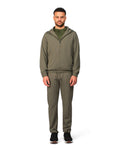 Man wearing a green tracksuit on a white background