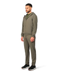 Man wearing a green tracksuit on a white background