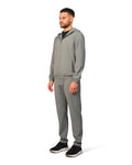 Man wearing a gray tracksuit on a white background