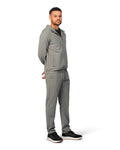 Man wearing a gray tracksuit on a white background