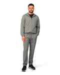 Man wearing a gray tracksuit on a white background