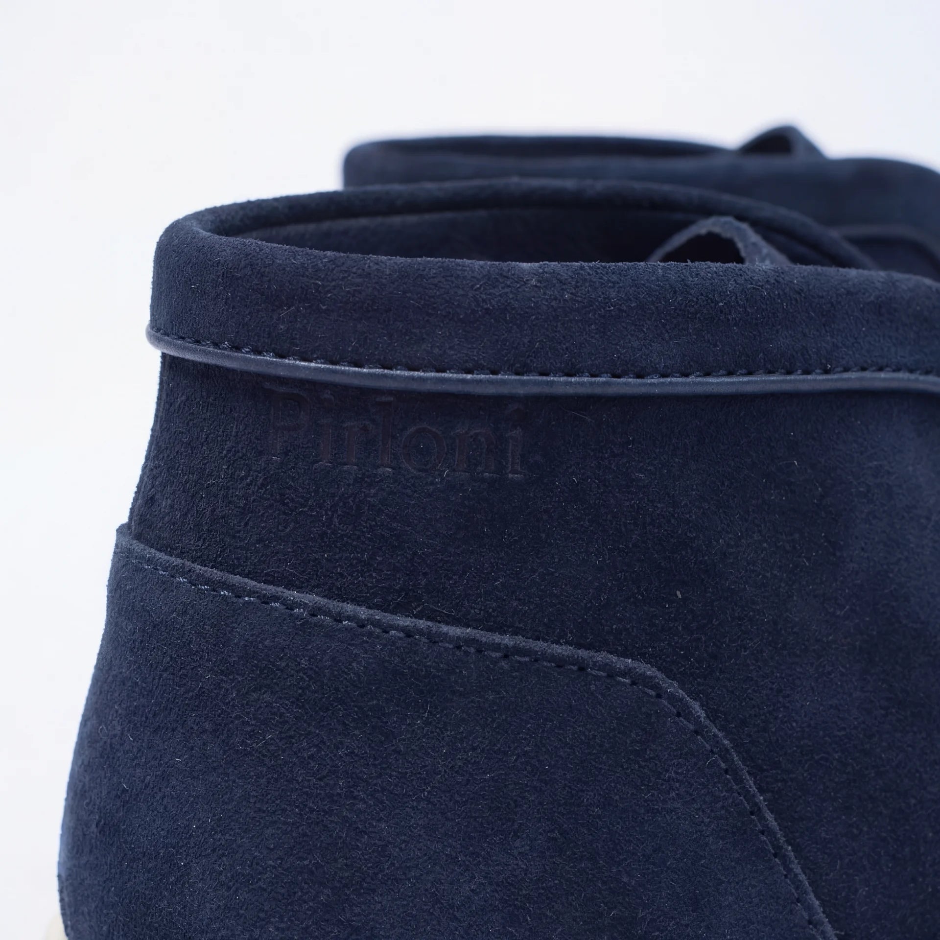 Navy blue suede shoe with brand logo on a white background