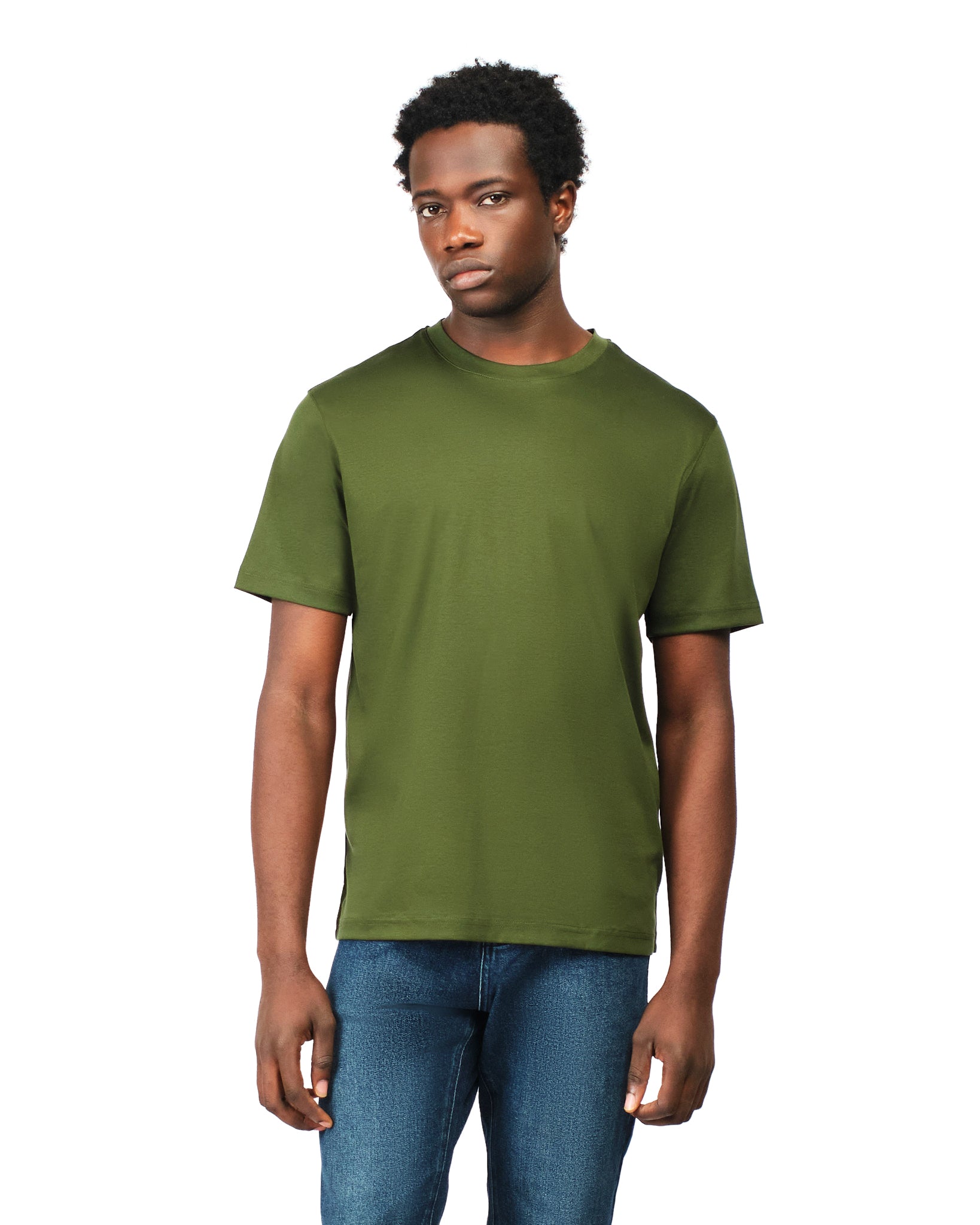 Man wearing a green t-shirt and blue jeans on a white background