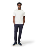 Man wearing a white t-shirt and navy pants on a white background