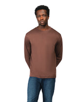 Man wearing a brown long-sleeve shirt and blue jeans on a white background