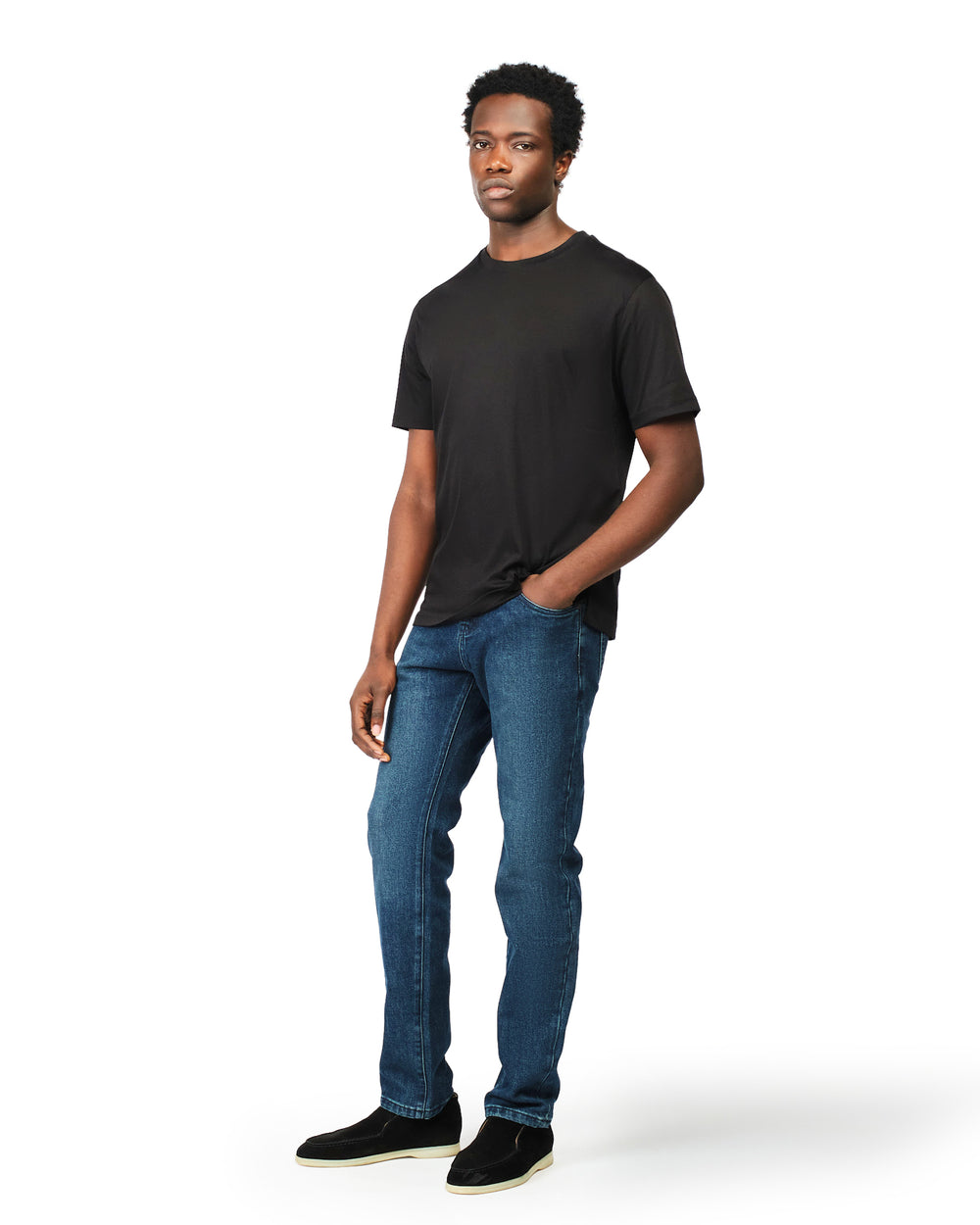 Man wearing a black t-shirt and blue jeans on a white background