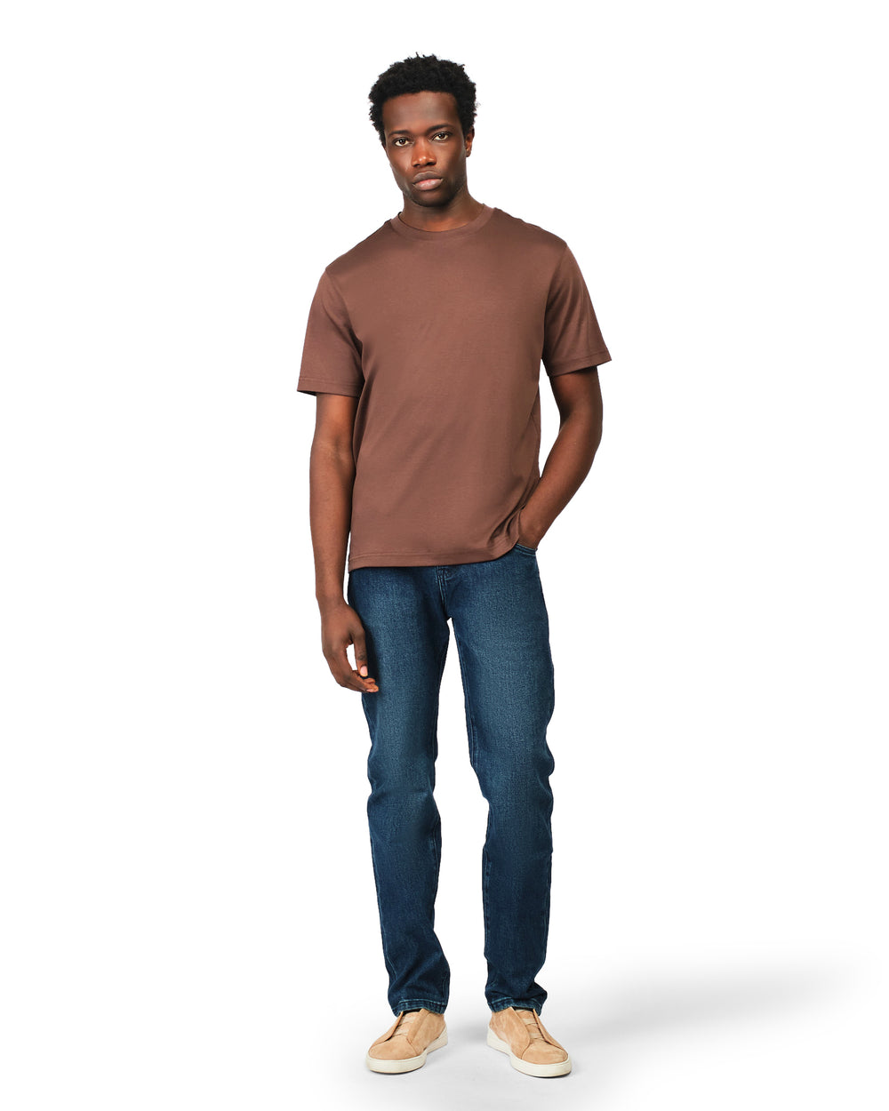 Man wearing a brown t-shirt and blue jeans on a white background