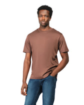 Man wearing a brown t-shirt and blue jeans on a white background