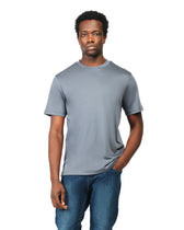 Man wearing a gray t-shirt and blue jeans on a white background