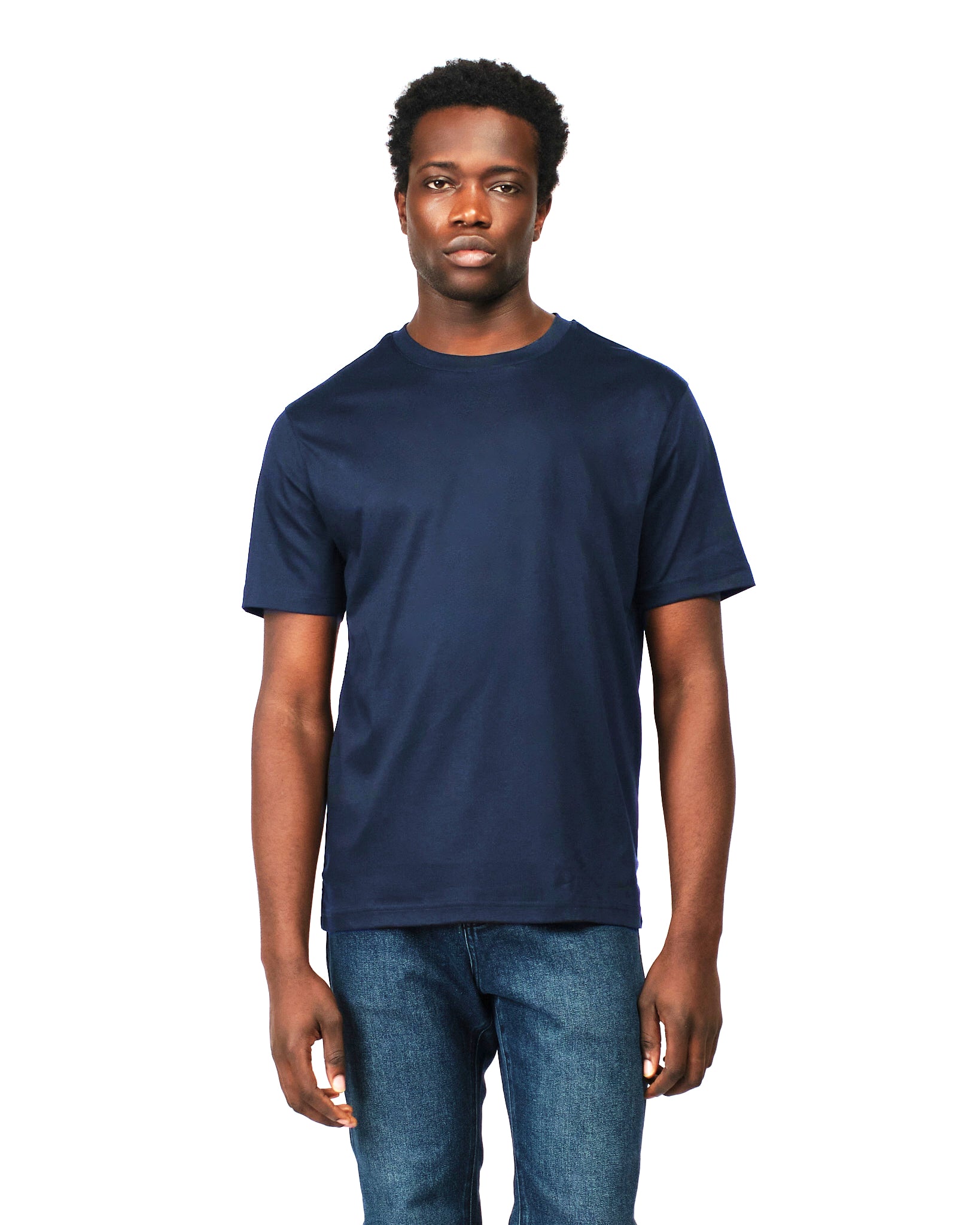 Man wearing a navy blue t-shirt and jeans on a white background