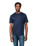 Man wearing a navy blue t-shirt and jeans on a white background