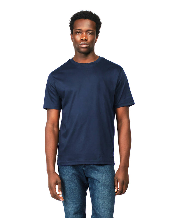 Man wearing a navy blue t-shirt and jeans on a white background