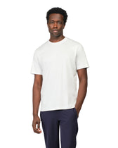 Man wearing a white t-shirt and navy pants on a white background