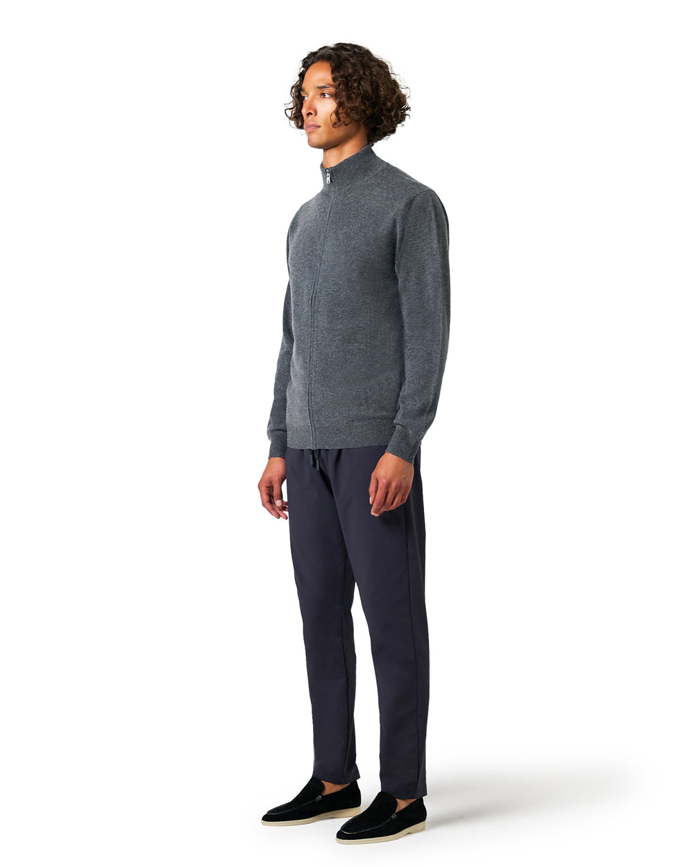 Man wearing a gray sweater and dark pants