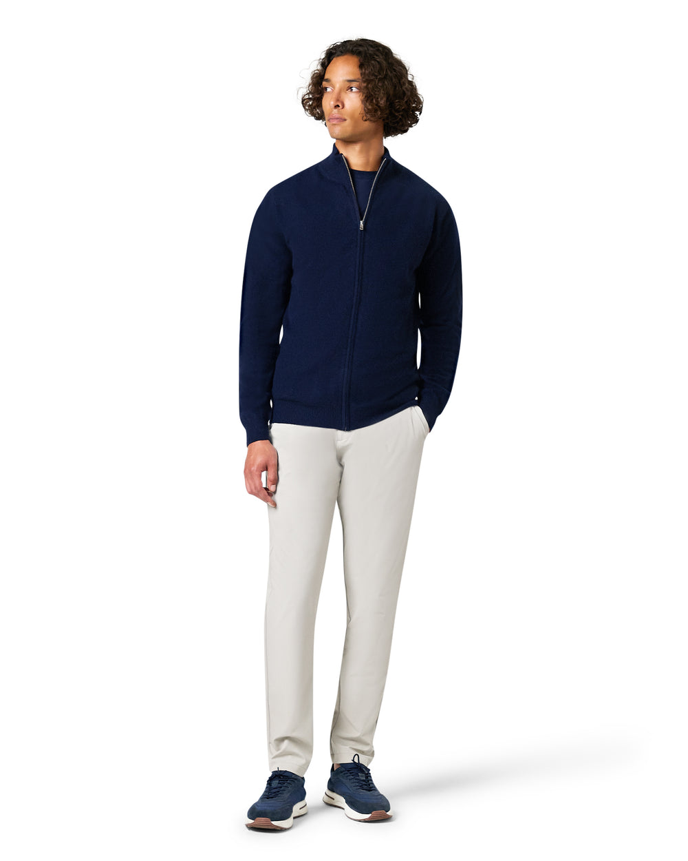 Man wearing a navy blue jacket and white pants