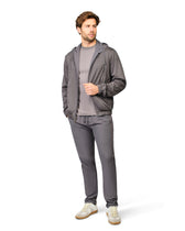 Man wearing a gray tracksuit on a white background