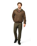 Man wearing a brown jacket and green pants on a white background