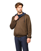 Man wearing a brown jacket with a navy hood on a white background