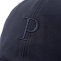 Close-up of a dark gray coat with buttons on a white background