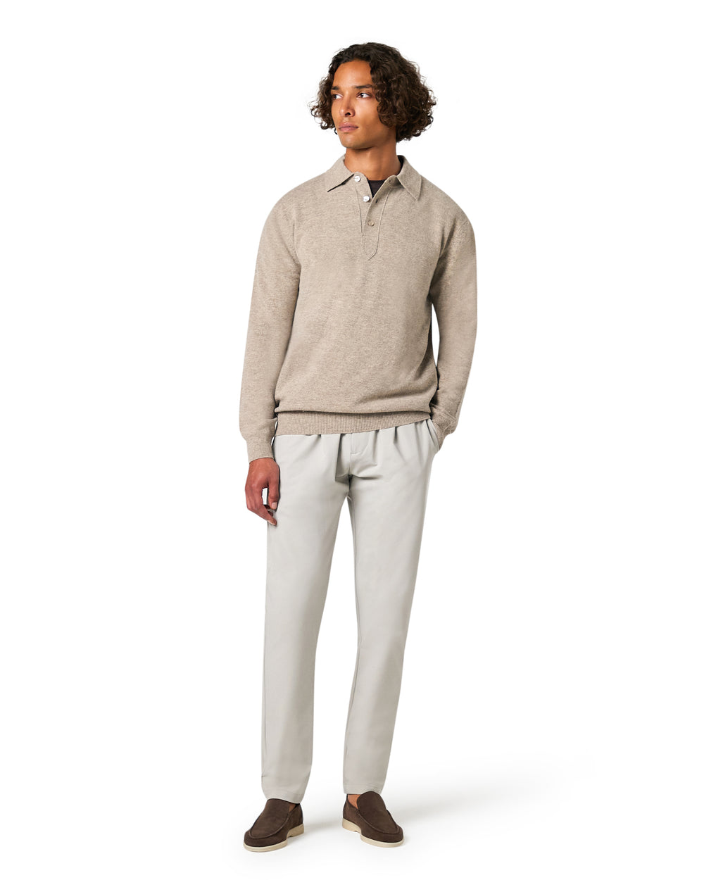 Man wearing a beige sweater and light gray pants 