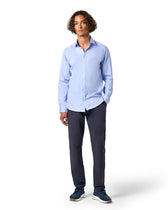 Man wearing a light blue shirt and dark pants