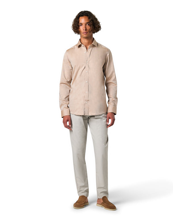 Man wearing a beige shirt and light gray pants 