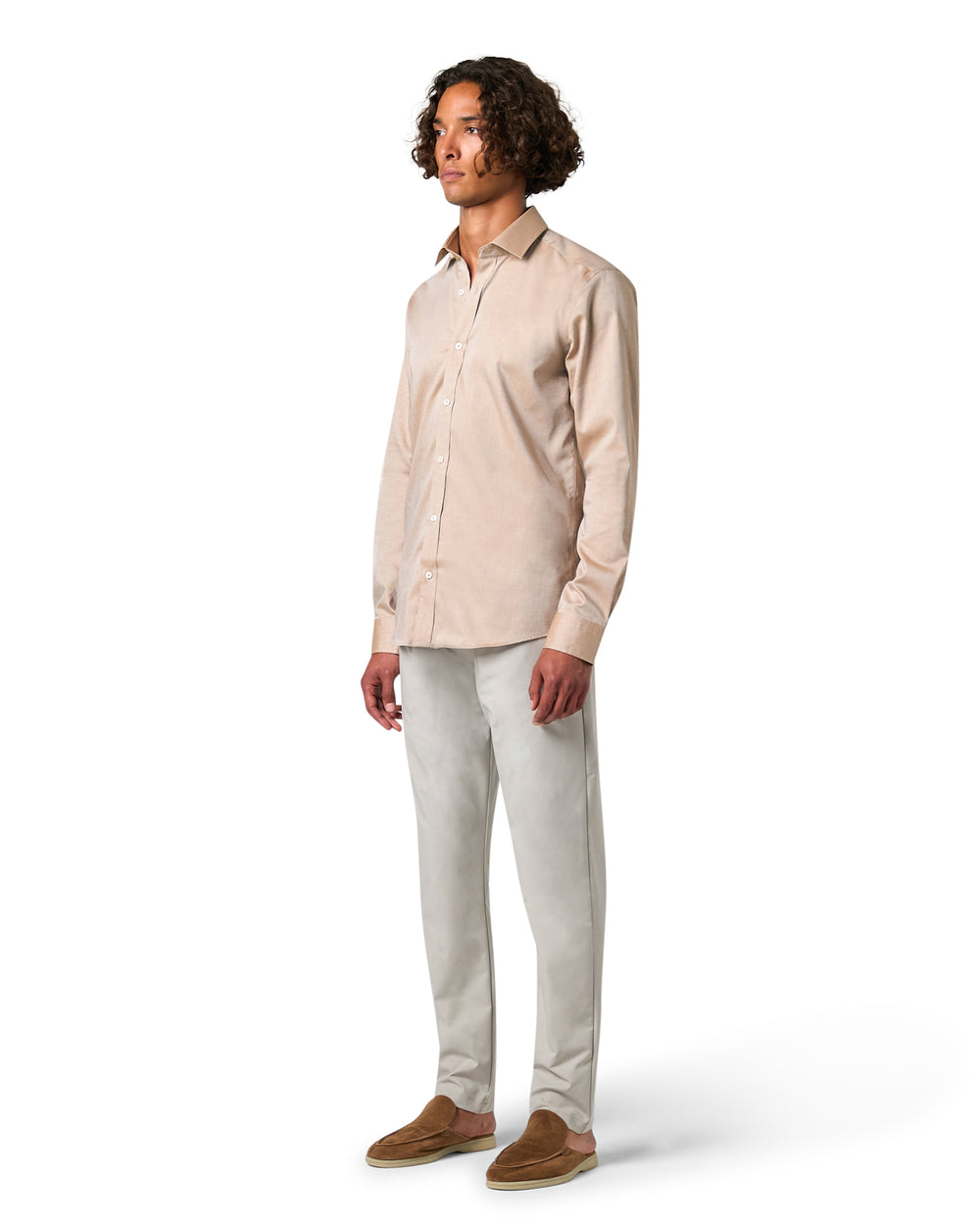 Man wearing a beige shirt and light gray pants 