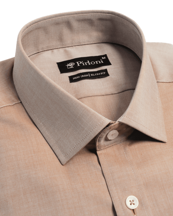 Close-up of a beige shirt collar with Pirloni label on a black background