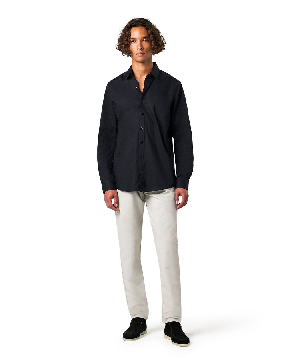 Man wearing a black shirt and white pants 