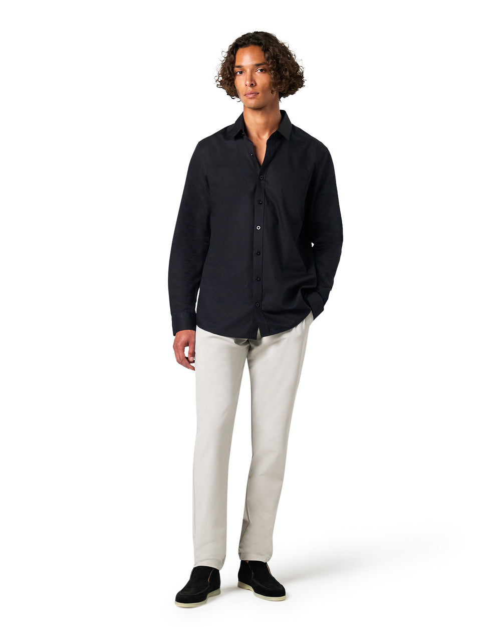 Man wearing a black shirt and white pants 