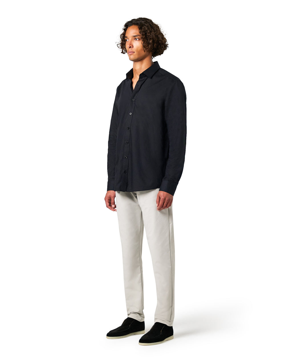 Man wearing a black shirt and light gray pants 