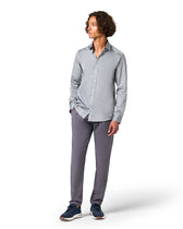 Person wearing a gray button-up shirt and pants 