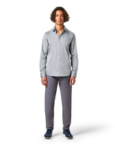 Man wearing a gray button-up shirt and pants 