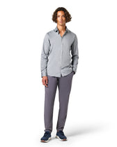 Man wearing a gray button-up shirt and pants