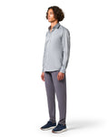 Man wearing a light gray button-up shirt and dark gray pants 