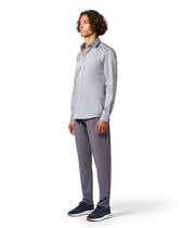 Man wearing a light gray button-up shirt and dark gray pants 