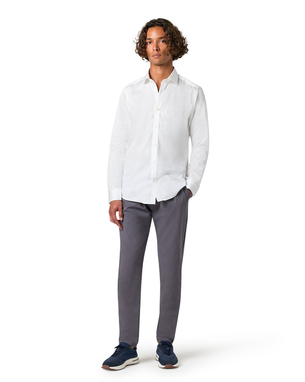 Man wearing a white shirt and gray pants