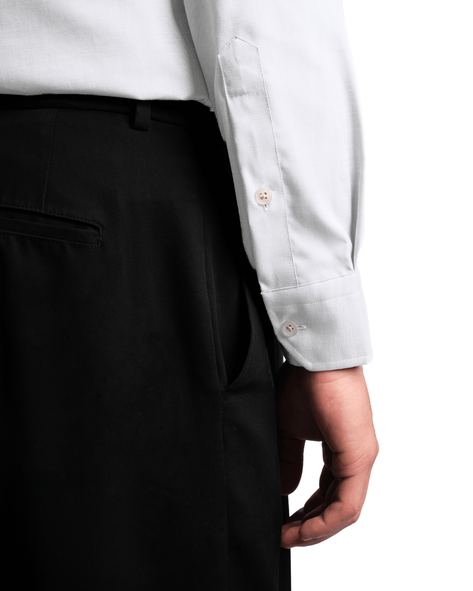 Person wearing a light gray dress shirt and black pants on a white background