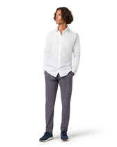 Person wearing a white shirt and gray pants