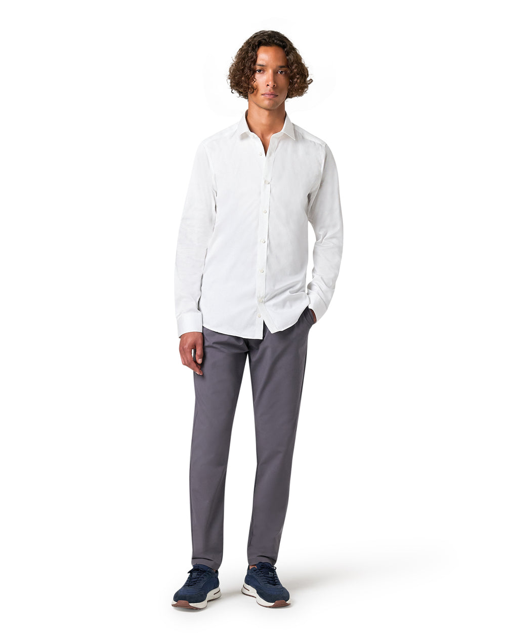 Man wearing a white shirt and gray pants 