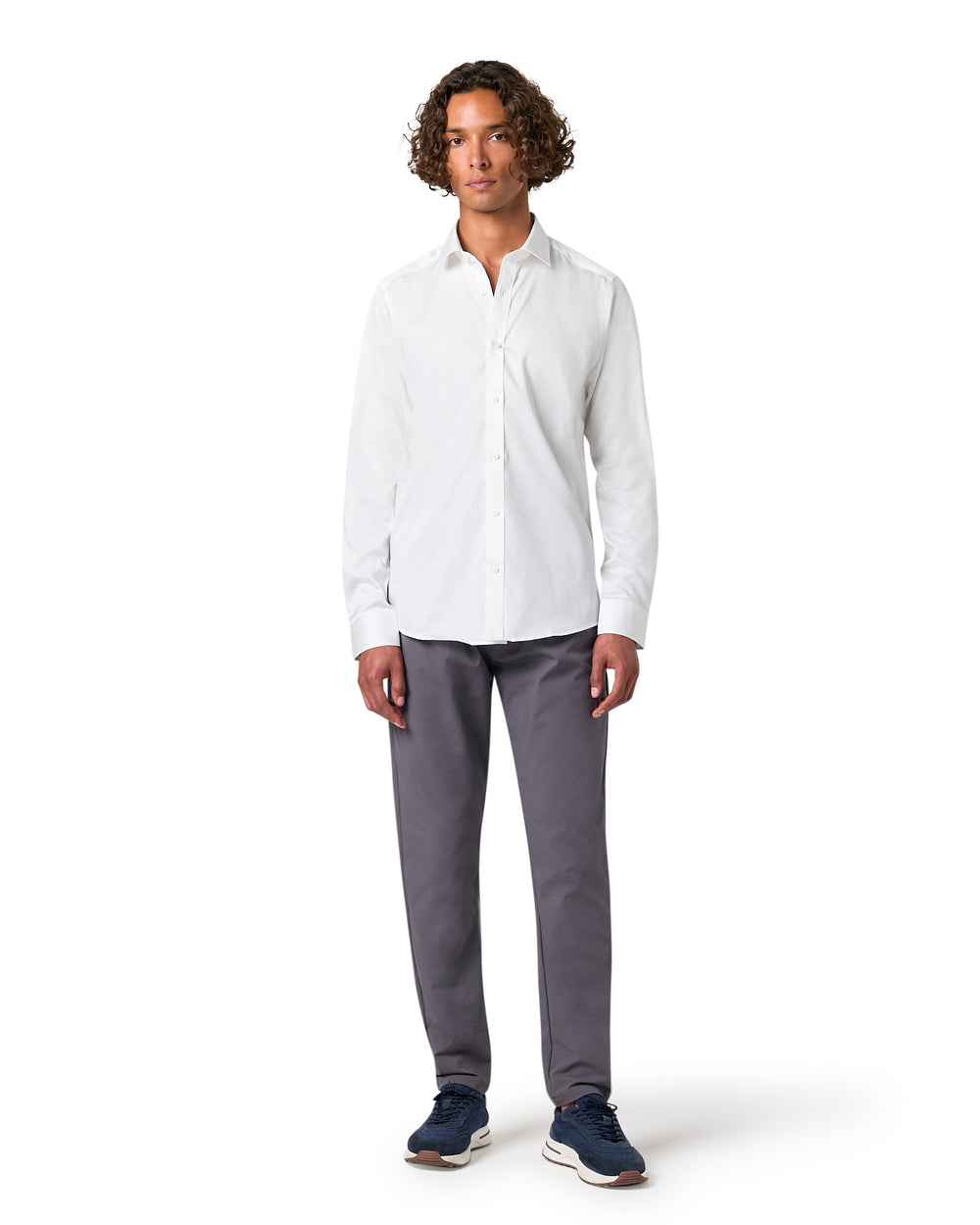 Man wearing a white shirt and gray pants