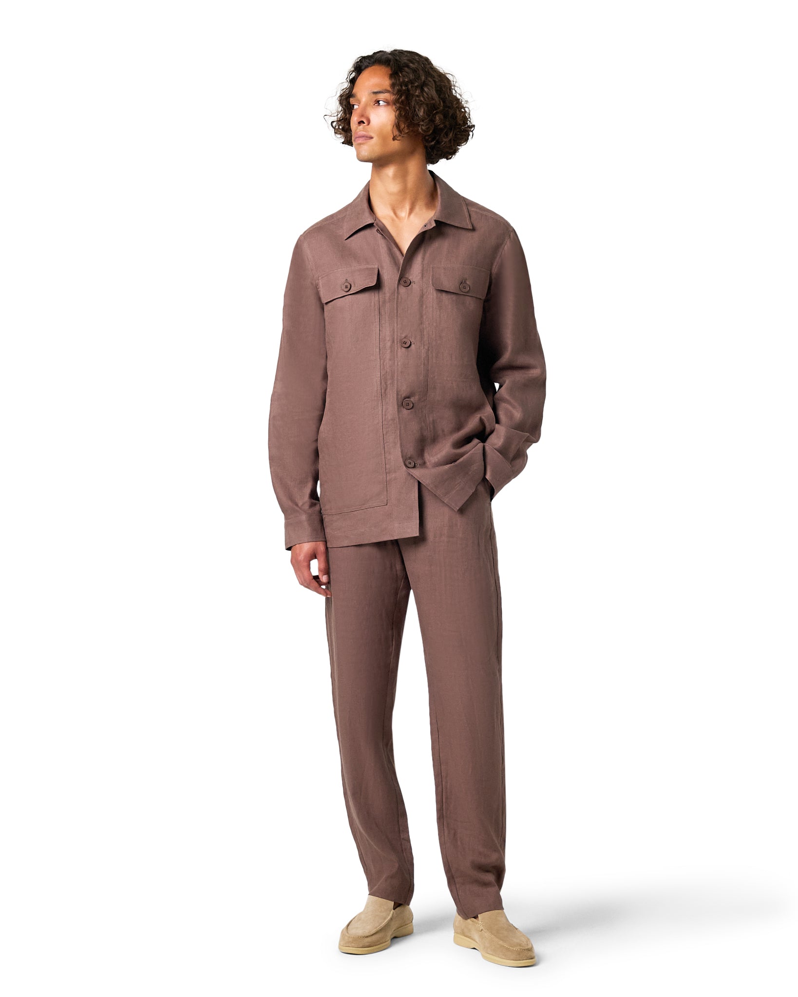 Man wearing a brown jumpsuit on a white background