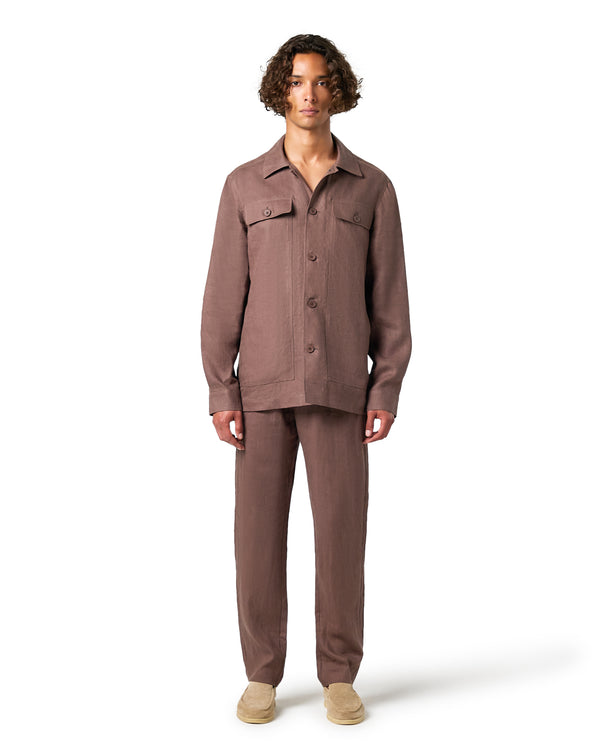 Man wearing a brown jacket and pants on a white background